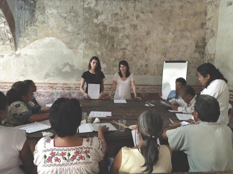 The co-founders of Kukua lead a workshop for women about moringa.