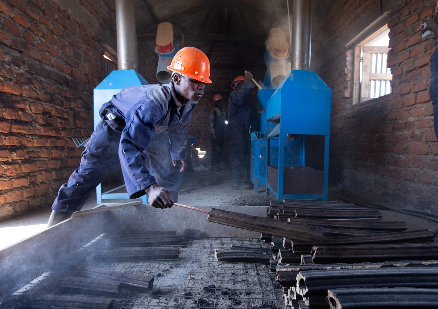 A worker producing clean cooking briquettes
